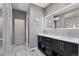 Modern bathroom with dual sinks, glass shower, and neutral color scheme at 11025 Watermark St, Parker, CO 80134