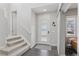 Welcoming entryway with stylish door, carpeted stairs, and view into adjacent room at 11025 Watermark St, Parker, CO 80134