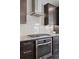 Modern kitchen with stainless steel appliances, granite countertops, and dark wood cabinets at 11025 Watermark St, Parker, CO 80134