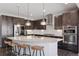 Contemporary kitchen with granite countertops, stainless steel appliances, and dark cabinetry at 11025 Watermark St, Parker, CO 80134