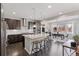 Spacious kitchen with large island, stainless steel appliances, dark wood cabinets, and adjoining dining area at 11025 Watermark St, Parker, CO 80134
