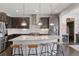 Modern kitchen with large island, stainless steel appliances, and stylish pendant lighting at 11025 Watermark St, Parker, CO 80134