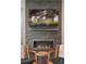 Cozy living room with stone fireplace, mounted TV, and comfortable seating at 11025 Watermark St, Parker, CO 80134