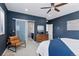 Stylish main bedroom with large windows, ceiling fan and carpet flooring at 11025 Watermark St, Parker, CO 80134