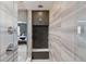 Contemporary walk-in shower features stylish tilework and a built-in bench, complemented by modern fixtures at 11025 Watermark St, Parker, CO 80134