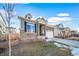 Landscaped front yard and stone accents highlight this charming home with a two-car garage at 26310 E 3Rd Pl, Aurora, CO 80018