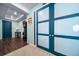 Entryway featuring blue doors, wood flooring, a table with a lamp and neutral walls and carpet at 26310 E 3Rd Pl, Aurora, CO 80018