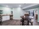 Well-lit kitchen with ample counter space and seating area flowing into living room at 26310 E 3Rd Pl, Aurora, CO 80018