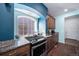 Kitchen area with gas range and granite countertops at 26310 E 3Rd Pl, Aurora, CO 80018