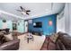 Inviting living room with a cozy seating arrangement and a tray ceiling with fan at 26310 E 3Rd Pl, Aurora, CO 80018