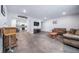 Spacious living room featuring bar, seating area, and convenient access to the kitchen at 26310 E 3Rd Pl, Aurora, CO 80018