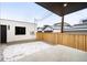 Cozy backyard with wooden fence, partial snow cover, and detached garages at 1823 W 35Th Ave, Denver, CO 80211