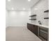 Modern basement bar features a geometric tile backsplash, floating shelves, and beverage cooler at 1823 W 35Th Ave, Denver, CO 80211