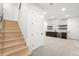 Finished basement features a modern bar with patterned tile backsplash, floating shelves, and a wine fridge at 1823 W 35Th Ave, Denver, CO 80211