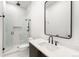 Modern bathroom features a glass-enclosed shower with black hardware and a sleek vanity with a vessel sink at 1823 W 35Th Ave, Denver, CO 80211