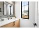 Stylish bathroom featuring a modern vanity, sleek fixtures, and elegant tile work at 1823 W 35Th Ave, Denver, CO 80211