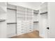 Organized walk-in closet featuring custom shelving, drawers, and ample storage space for clothing at 1823 W 35Th Ave, Denver, CO 80211