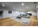 Finished basement Gathering room with hardwood floors and large area rug at 1518 S Columbine St, Denver, CO 80210