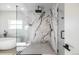 Modern bathroom featuring a frameless glass walk-in shower and soaking tub with black hardware at 1518 S Columbine St, Denver, CO 80210