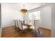 Dining room featuring a glass table, seating for eight, and a modern light fixture at 1518 S Columbine St, Denver, CO 80210