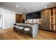 Bright kitchen with wood cabinets, a center island with seating and modern light fixtures overhead at 1518 S Columbine St, Denver, CO 80210