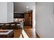 Bright and airy open kitchen featuring an island, seating, wooden cabinetry, and sleek appliances at 1518 S Columbine St, Denver, CO 80210