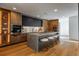 Modern kitchen features wood cabinetry, stainless appliances, and a large center island with seating at 1518 S Columbine St, Denver, CO 80210