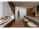 Open-concept kitchen with seating at the island and a fireplace visible in the adjoining room at 1518 S Columbine St, Denver, CO 80210