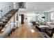 Open concept living space with wood staircase, hardwood floors, and glass enclosed wine storage at 1518 S Columbine St, Denver, CO 80210