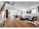 Bright open-concept living room featuring wood floors, modern decor, and glass-enclosed wine display at 1518 S Columbine St, Denver, CO 80210