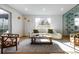 Living room with a couch, coffee table, modern floor lamp, and glass-enclosed wine storage at 1518 S Columbine St, Denver, CO 80210