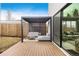 Outdoor patio area with modern pergola, stylish seating, and a sliding glass door at 1518 S Columbine St, Denver, CO 80210