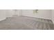Large basement space showcasing patterned carpeting, a window for natural light, and a flexible open layout at 6514 Agave Ave, Castle Rock, CO 80108