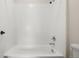 Bright bathroom featuring a clean, white tiled shower-over-tub, complemented by sleek chrome fixtures at 6514 Agave Ave, Castle Rock, CO 80108