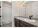 Bathroom with dark wood vanity and granite countertop, with bath and shower combo at 6514 Agave Ave, Castle Rock, CO 80108