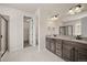Bathroom featuring double sink vanity, granite countertop and a glass enclosed shower at 6514 Agave Ave, Castle Rock, CO 80108