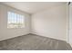 A carpeted bedroom with a window, and neutral colored walls at 6514 Agave Ave, Castle Rock, CO 80108