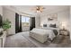 Comfortable bedroom with a tray ceiling, large windows and a cozy carpet at 6514 Agave Ave, Castle Rock, CO 80108