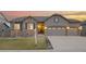 Charming single-story home with stone accents, gray siding, and a three-car garage at 6514 Agave Ave, Castle Rock, CO 80108