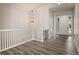 Welcoming foyer featuring durable wood-look floors, a white staircase, and abundant natural light at 6514 Agave Ave, Castle Rock, CO 80108