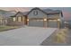 Charming home exterior featuring a three-car garage, beautiful stone accents, and a well-manicured lawn at 6514 Agave Ave, Castle Rock, CO 80108