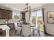 Eat-in kitchen with modern lighting, dark cabinets, and sliding glass doors to backyard at 6514 Agave Ave, Castle Rock, CO 80108