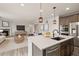 Open-concept kitchen with quartz countertops, stainless steel appliances, and a view of the living room at 6514 Agave Ave, Castle Rock, CO 80108