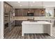 Modern kitchen with an island, stainless steel appliances, and stylish pendant lighting at 6514 Agave Ave, Castle Rock, CO 80108