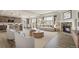 Open-concept living space with a brick fireplace, neutral furniture, and seamless flow to the kitchen at 6514 Agave Ave, Castle Rock, CO 80108