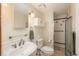 Cozy bathroom features a pedestal sink and a tiled shower with glass door at 800 N Pearl St # 702, Denver, CO 80203