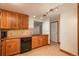 Charming kitchen with wooden cabinets, tile backsplash, and black appliances at 800 N Pearl St # 702, Denver, CO 80203