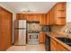 Cozy kitchen has stainless steel appliances, wooden cabinets, and lovely countertops at 800 N Pearl St # 702, Denver, CO 80203
