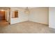 Open living room featuring neutral carpeting, overhead lighting, and access to the kitchen with a breakfast bar at 800 N Pearl St # 702, Denver, CO 80203