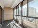 Bright sun room with brick accent wall, gray carpet flooring and windows overlooking the city at 800 N Pearl St # 702, Denver, CO 80203